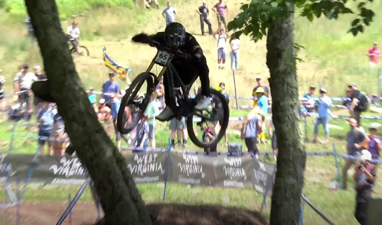 Stylish rider jumping between two trees